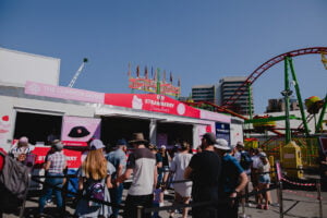 Busy Strawberry Sundae stall inside sideshow alley at Ekka 2023