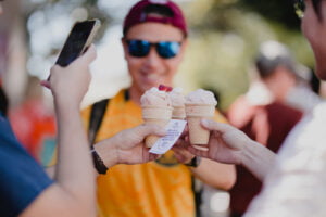 Group of friends taking photos of Strawberry Sundaes at Ekka 2023