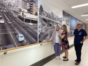Patient and clinicians looking at photos in Memory Lane