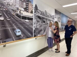 Patient and clinicians looking at photos in Memory Lane 